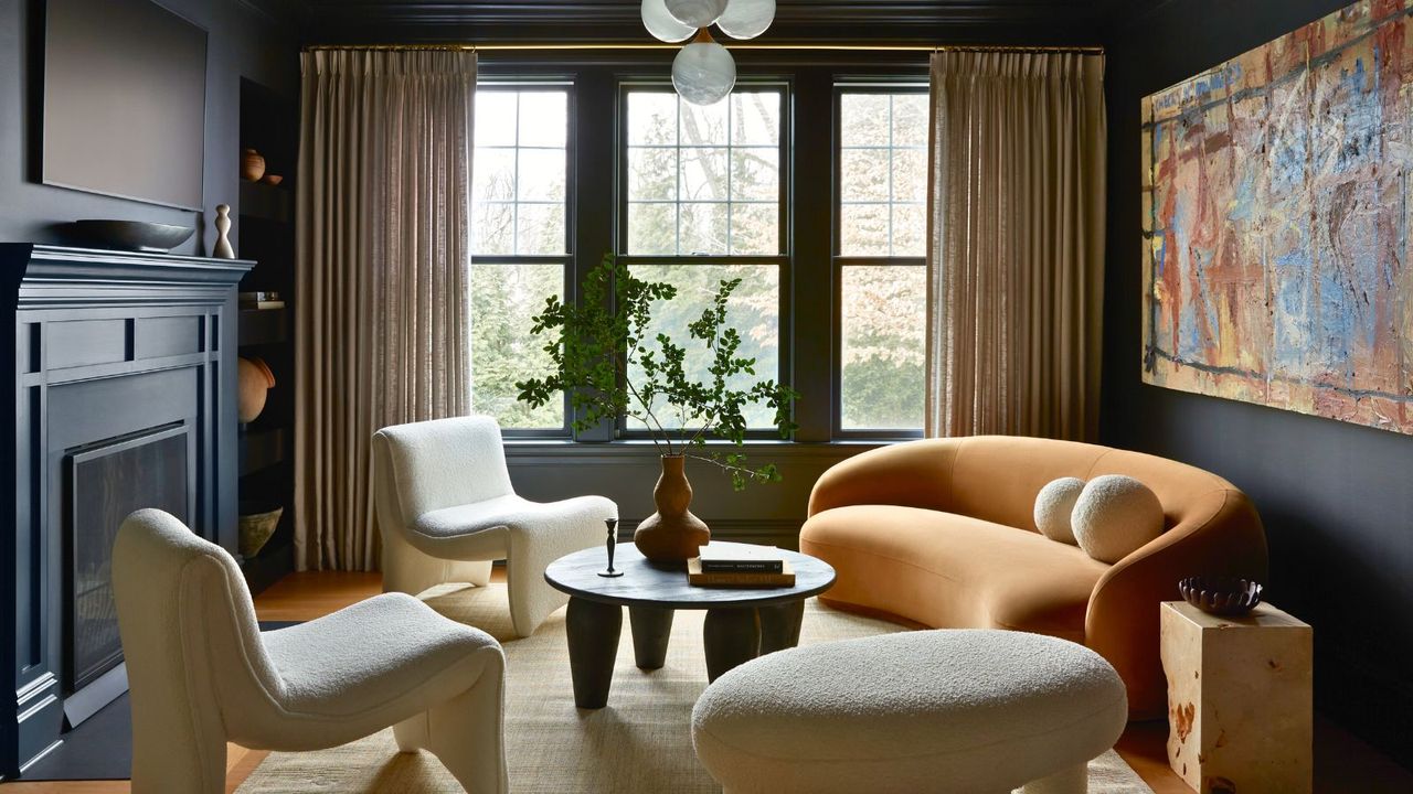 living room with dark walls and yellow sofa and large artwork