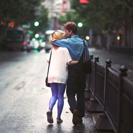 Man and woman walking and kissing
