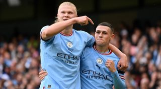 Phil Foden and Erling Haaland celebrate after scoring a hat-trick apiece for Manchester City in the derby against Manchester United.