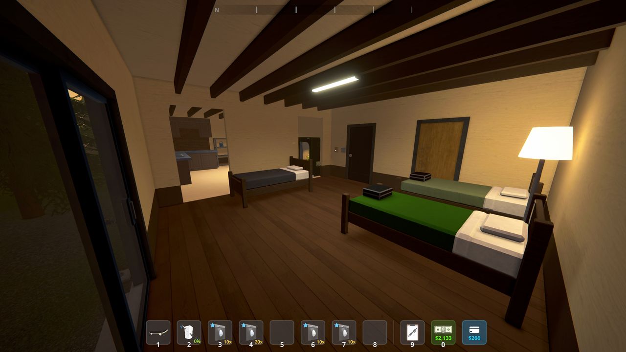 Best Schedule 1 bungalow setup - A view of the bedroom, with three beds and a lamp, and the kitchen in the next room.