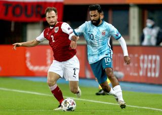 Andreas Ulmer of Austria and Ghayas Zahid of Norway challenge for the ball