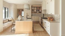 kitchen with white cabinetry and wooden island and floor