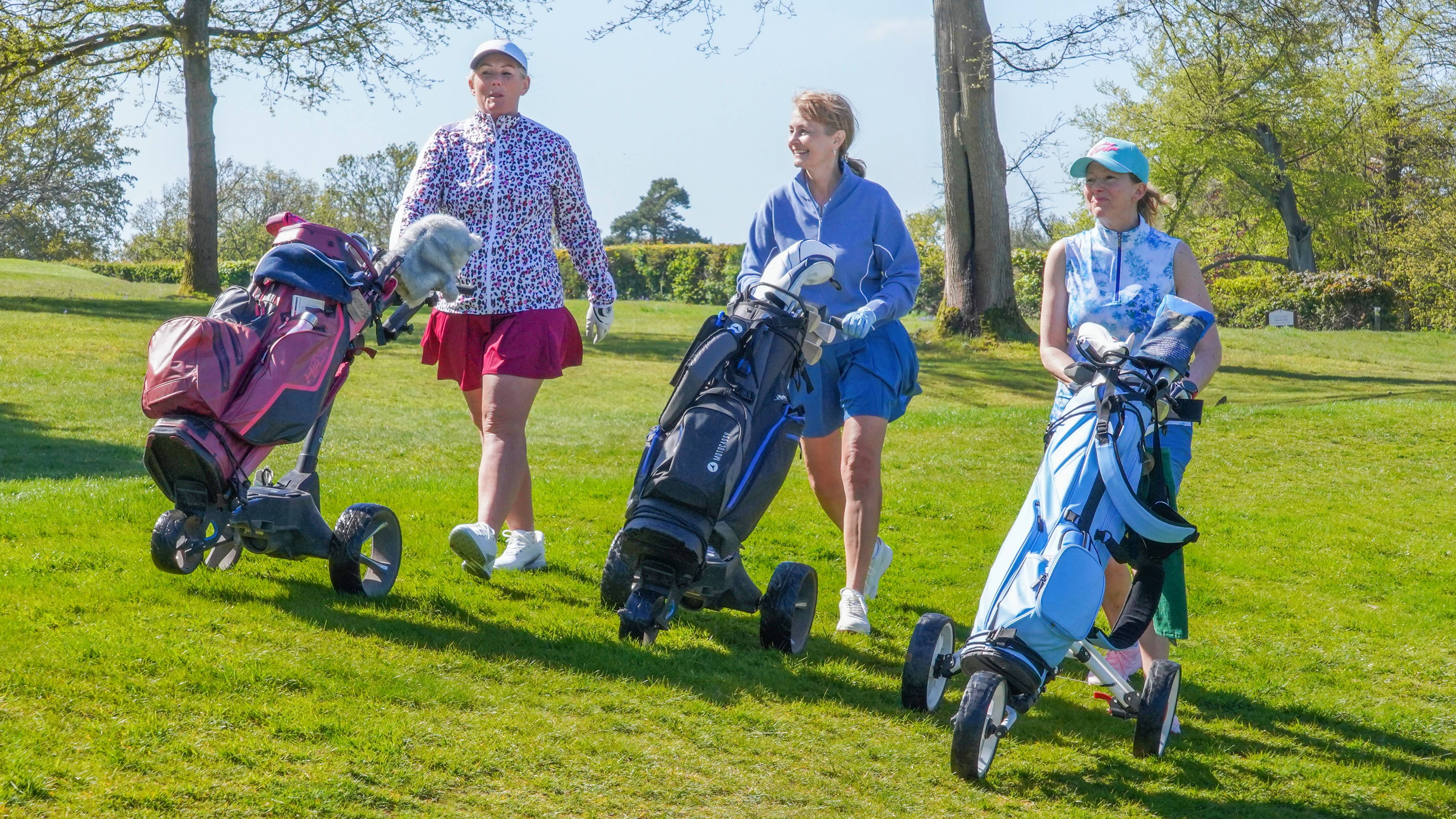 Female golfers waking on the fairway