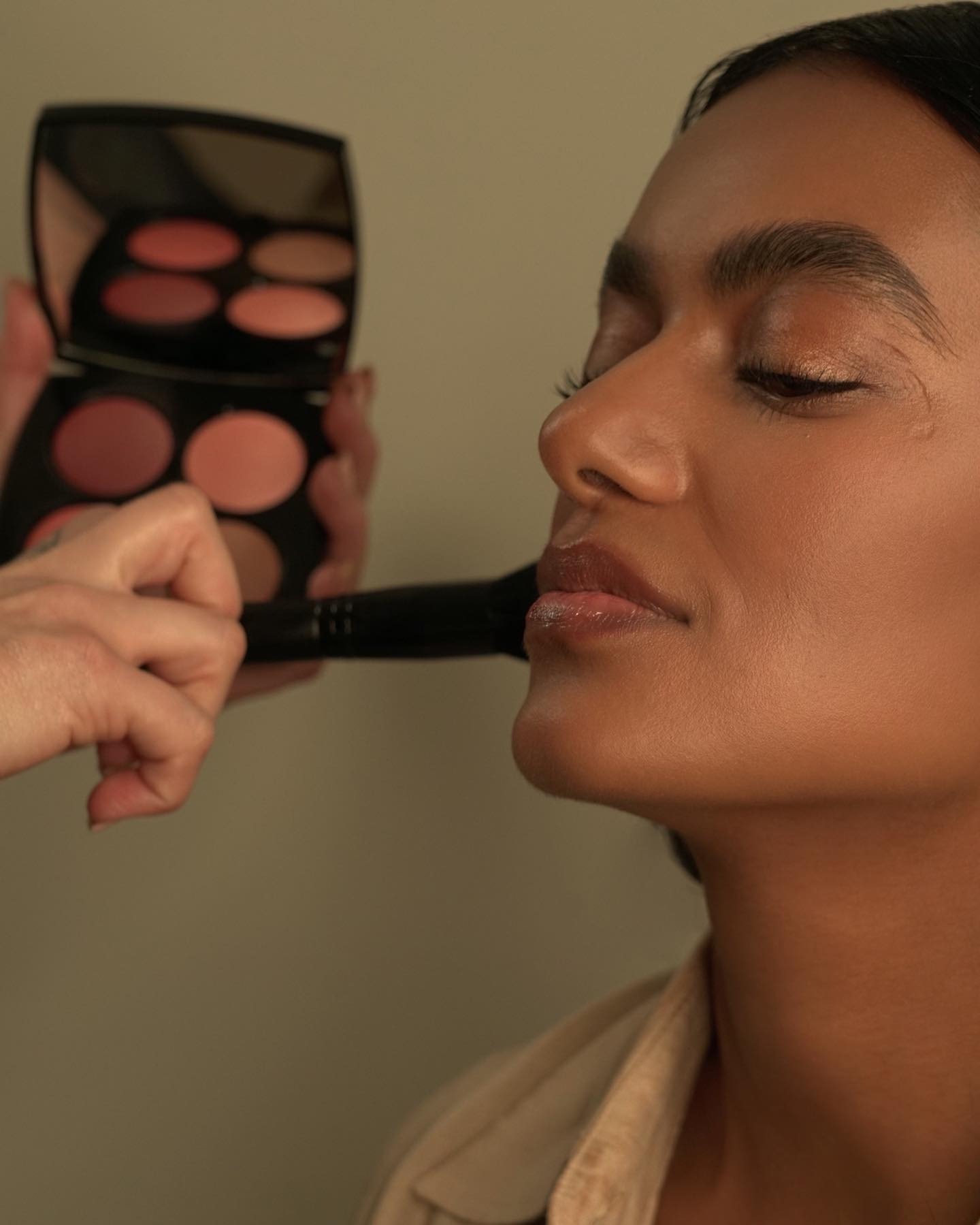 A woman getting her complexion makeup done.
