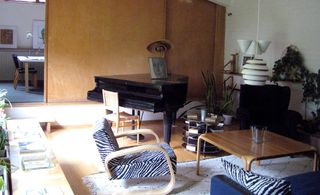living room with black piano and zebra stripe pattern seating