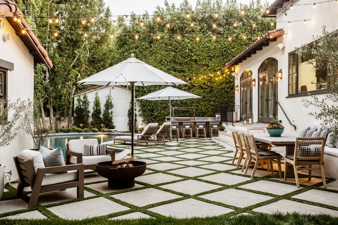 luxury pool patio area with seating and white umbrellas