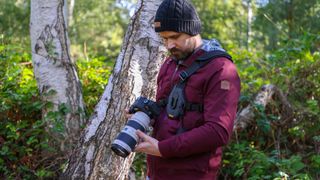 Cotton Carrier Skout G2 worn by a man in a burgandy jacket outdoors in a woods