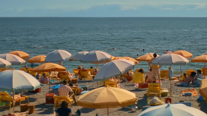 Beach world with its yellow and blue umbrellas stretches to the horizon in eternity. 
