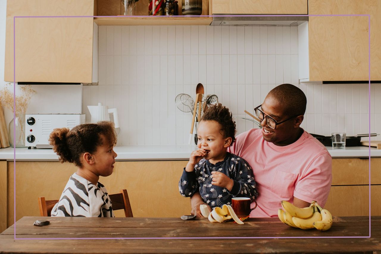 Man with two children sat at a table