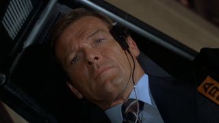 Roger Moore making a face of discomfort in a centrifuge in Moonraker.