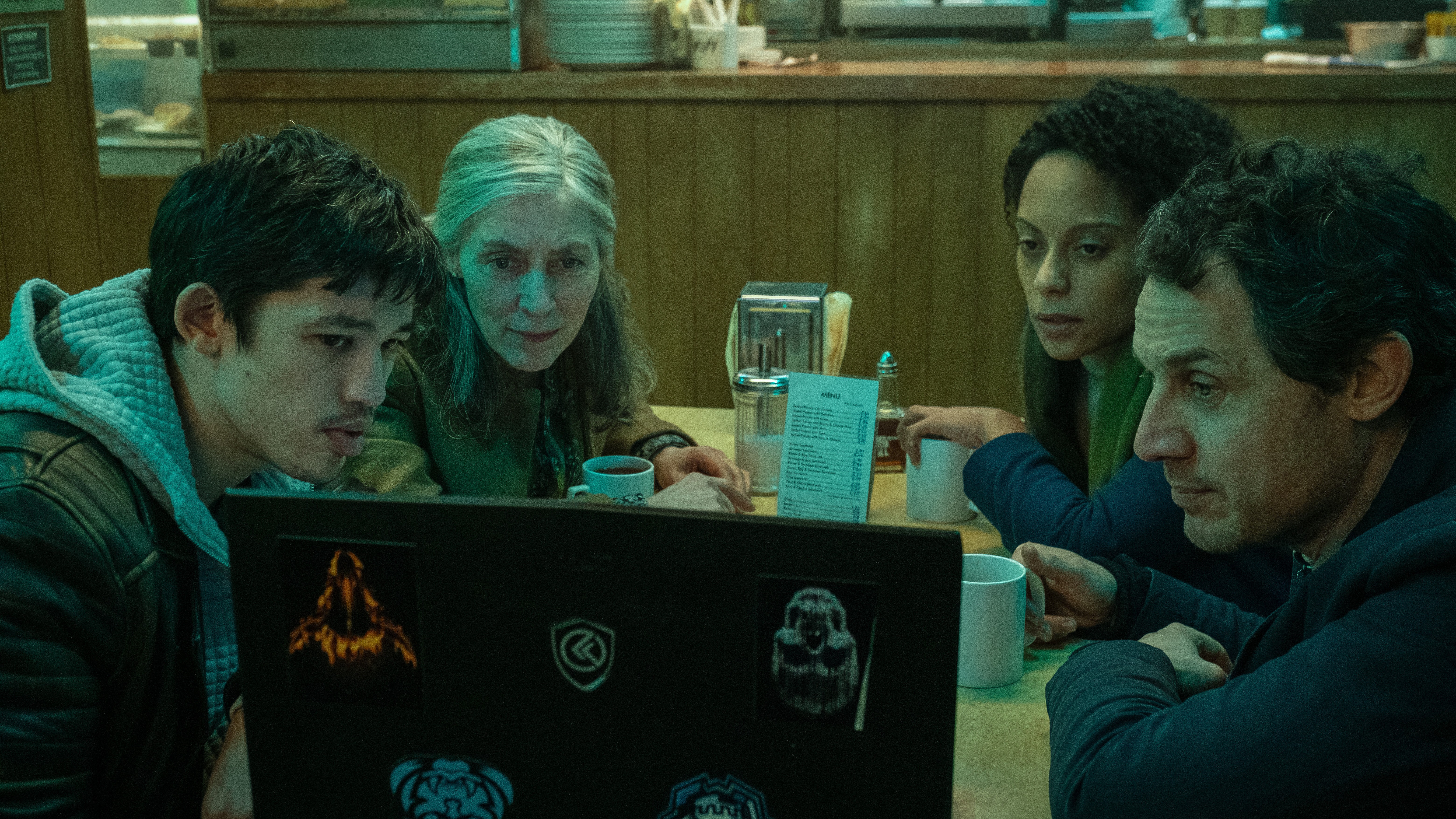 Roddy (Christopher Chung), Standish (Saskia Reeves), Louisa (Rosalind Eleazar) and Min (Dustin Demri-Burns) look at a laptop in 