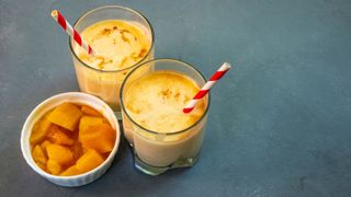 Mango lassi in glass with paper straws