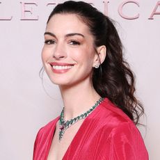 Anne Hathaway attended a Bulgari event in Milan dressed in a red ballgown and Bulgari jewelry
