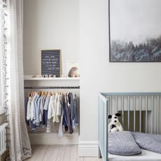 Kids room with hanging clothes rail in alcove