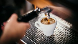 An espresso machine making a cup of coffee