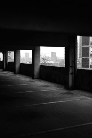 Black-and-white image of housing blocks, framed by windows in a car park, taken on the Leica SL3-S with a Leica Summilux SL 50mm f/1.4 Asph lens