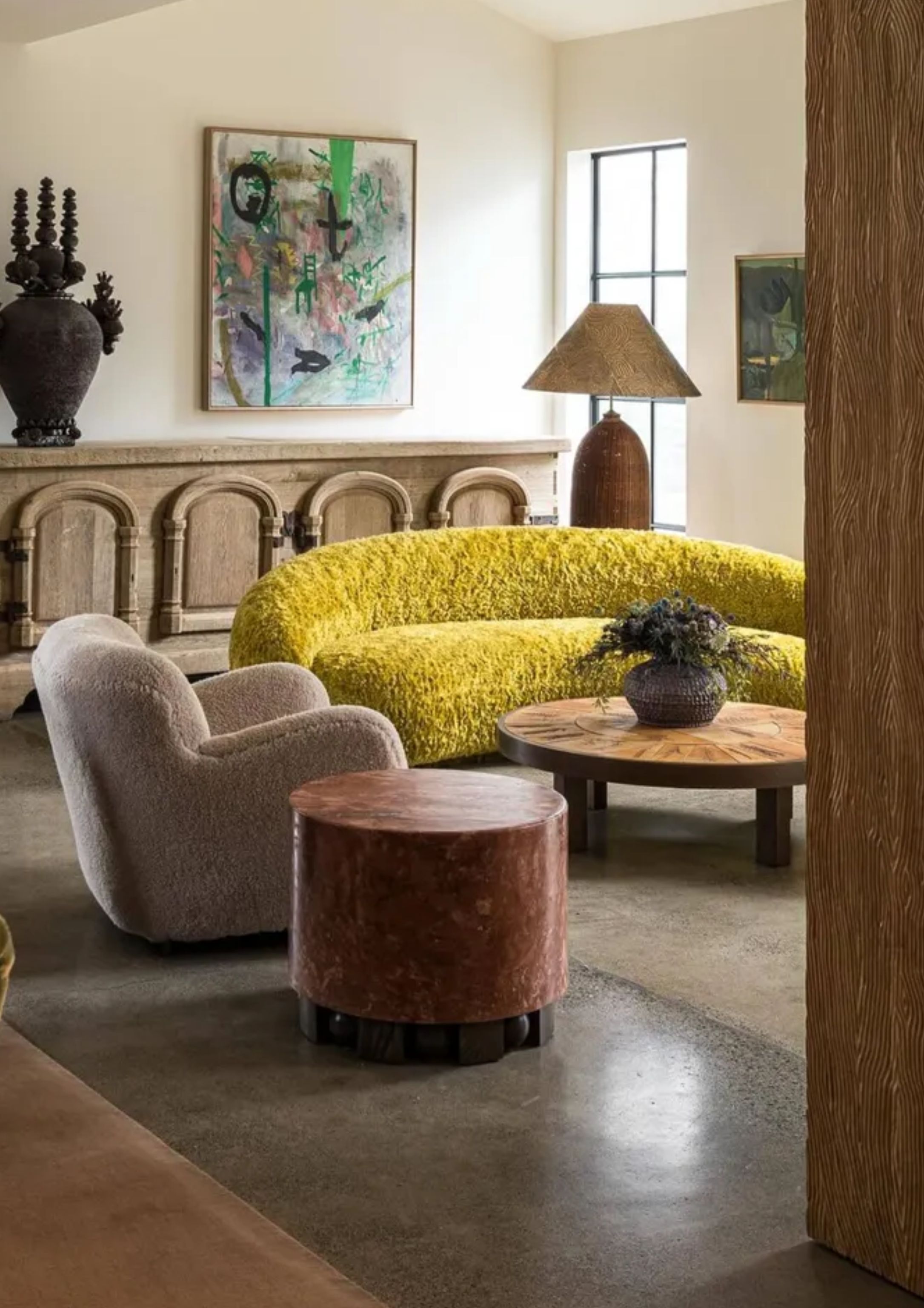 a yellow textured couch in a neutral living room