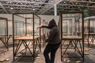 Kader Attia smashes up his Arab Spring (2014) installation at Art Basel Unlimited, 2015, Galleria Continua. © Art Basel