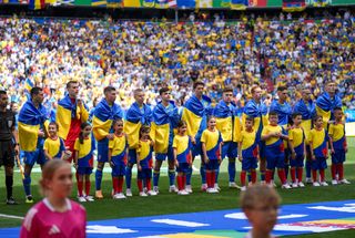 Players of Ukraine line up during national anthem ceremony ahead of the 2024 European Football Championship (EURO 2024) Group E football match between Romania and Ukraine at Allianz Arena in Munich, Germany on June 17, 2024.