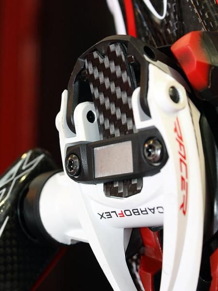 The carbon blade flexes as the rear latch opens.