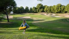 Katie Dawkins walking alone on fairway