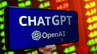 The ChatGPT and OpenAI logo on a smartphone in front of stocks and shares data on a big screen