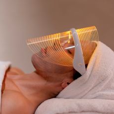 a woman wearing one of the best led face masks