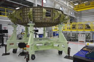 The upper and lower dome of the CST-100 "Starliner" structural test article is seen inside Boeing's Commercial Crew and Cargo Processing Facility (C3PF), Sept. 4, 2015.