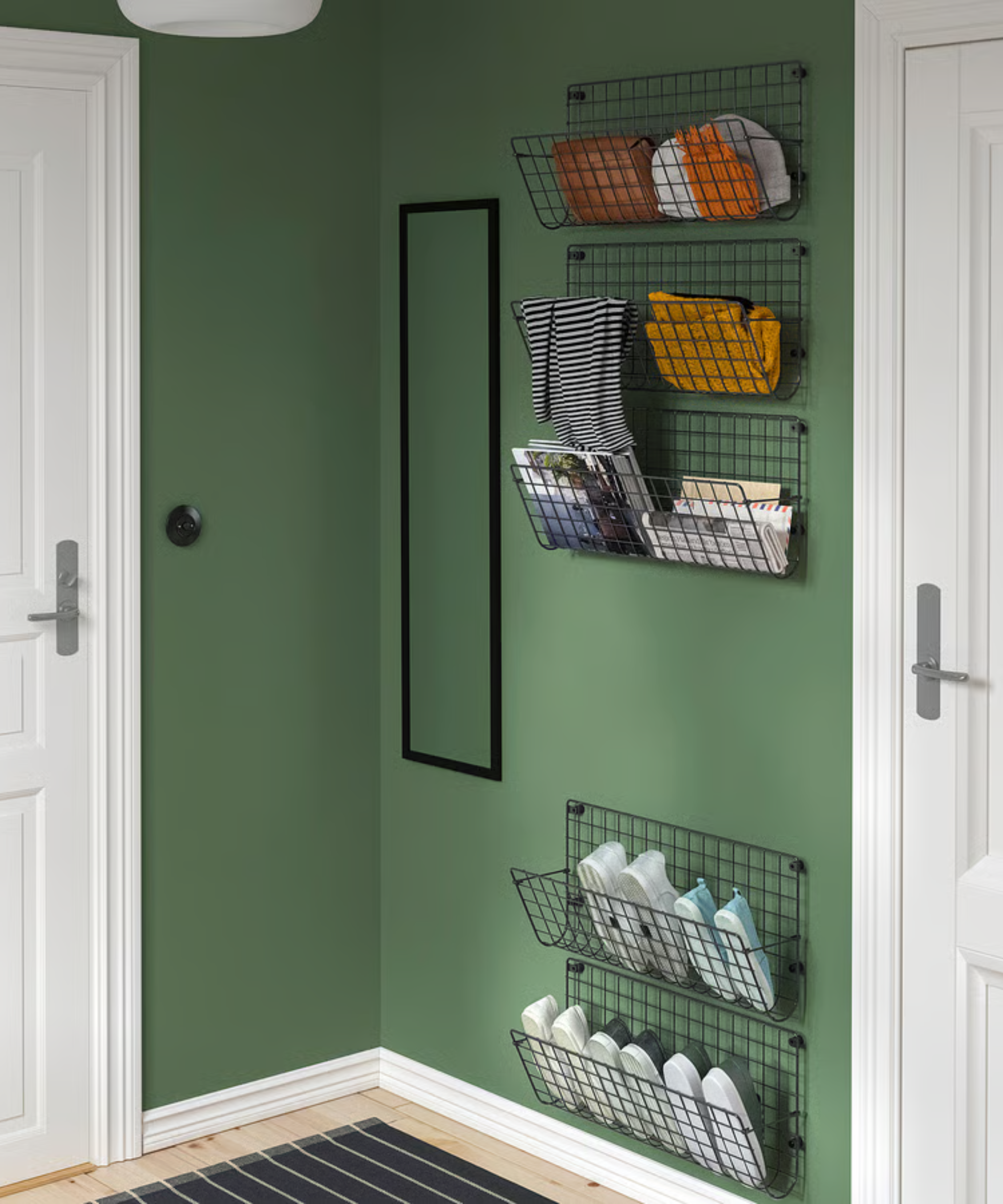 a black metal wall shelving unit in a green painted room