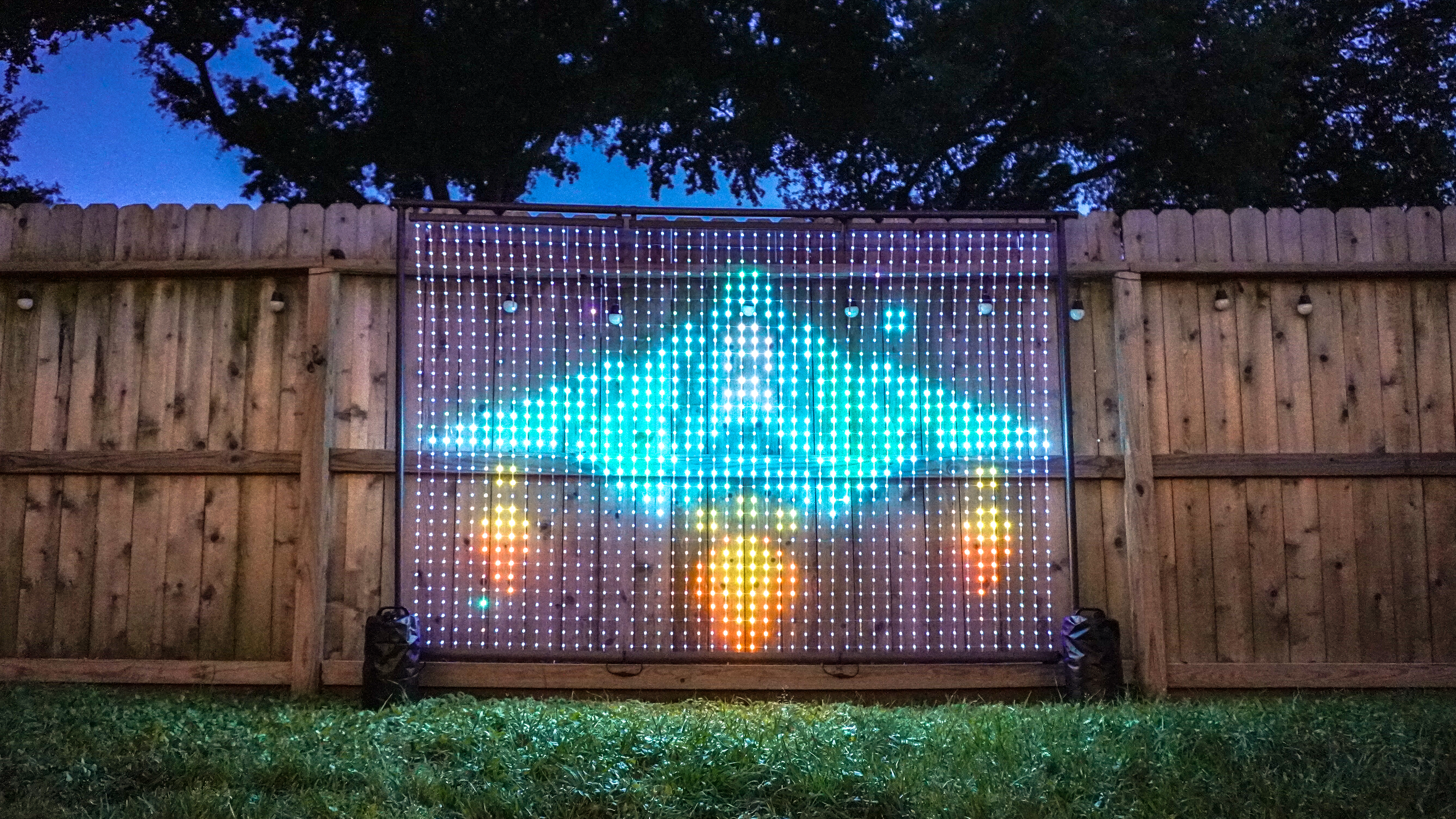The Govee Lightwall outside by a fence displaying a GIF of a spaceship