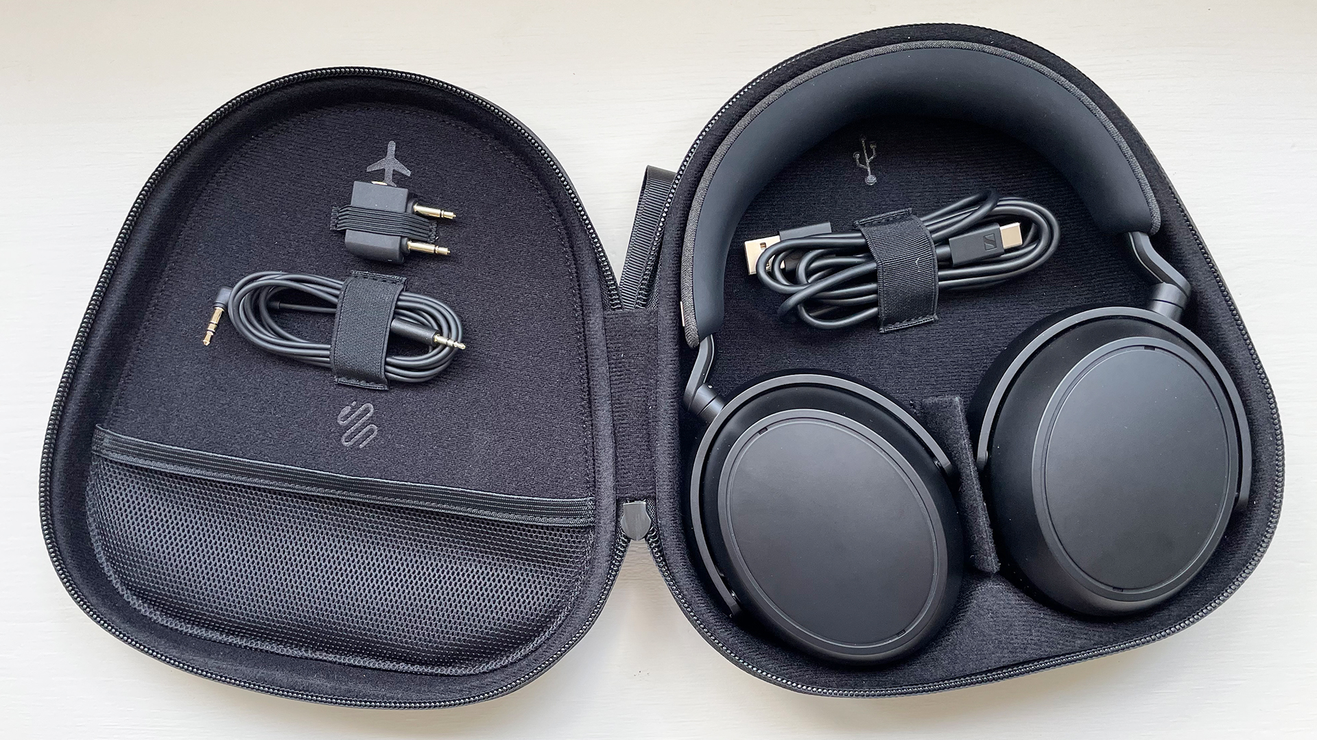 Sennheiser Momentum 4 Wireless in carry case with accessories on a window seat at the reviewer's home
