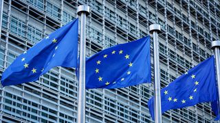 Flags of the European Union in front of the Berlaymont Building, which houses the European Commission's headquarters in Brussels, Belgium