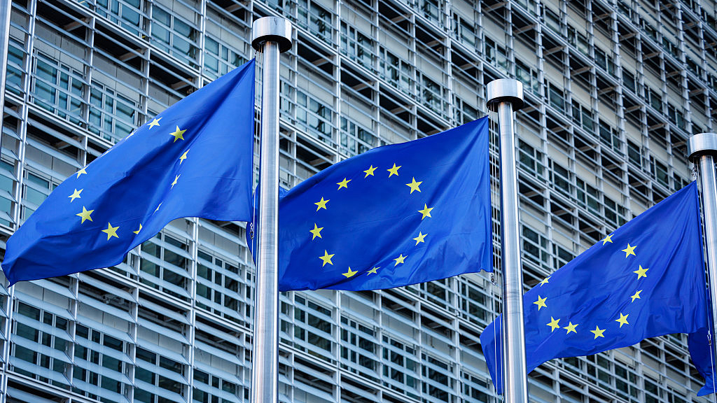 Flags of the European Union in front of the Berlaymont Building, which houses the European Commission&#039;s headquarters in Brussels, Belgium