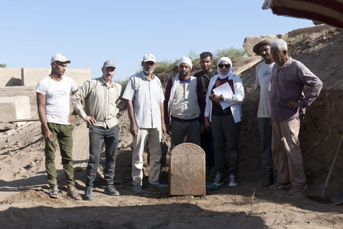 Photos from an archaeological dig, showing a brown stone tablet with hieroglyphics written on it, a group of people standing around the tablet, and a shot of the ruins of an ancient city