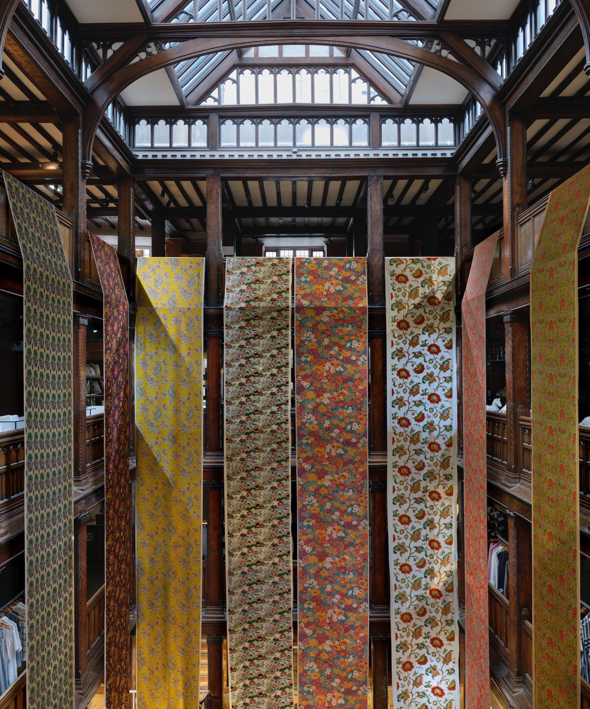 The inside of the Liberty store with runs of floral fabric cascading down different floors