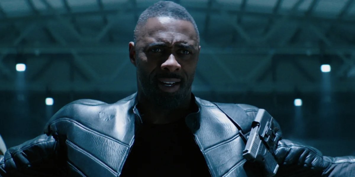 Fast &amp; Furious Presents: Hobbs and Shaw Idris Elba holding his arms up in a warehouse.