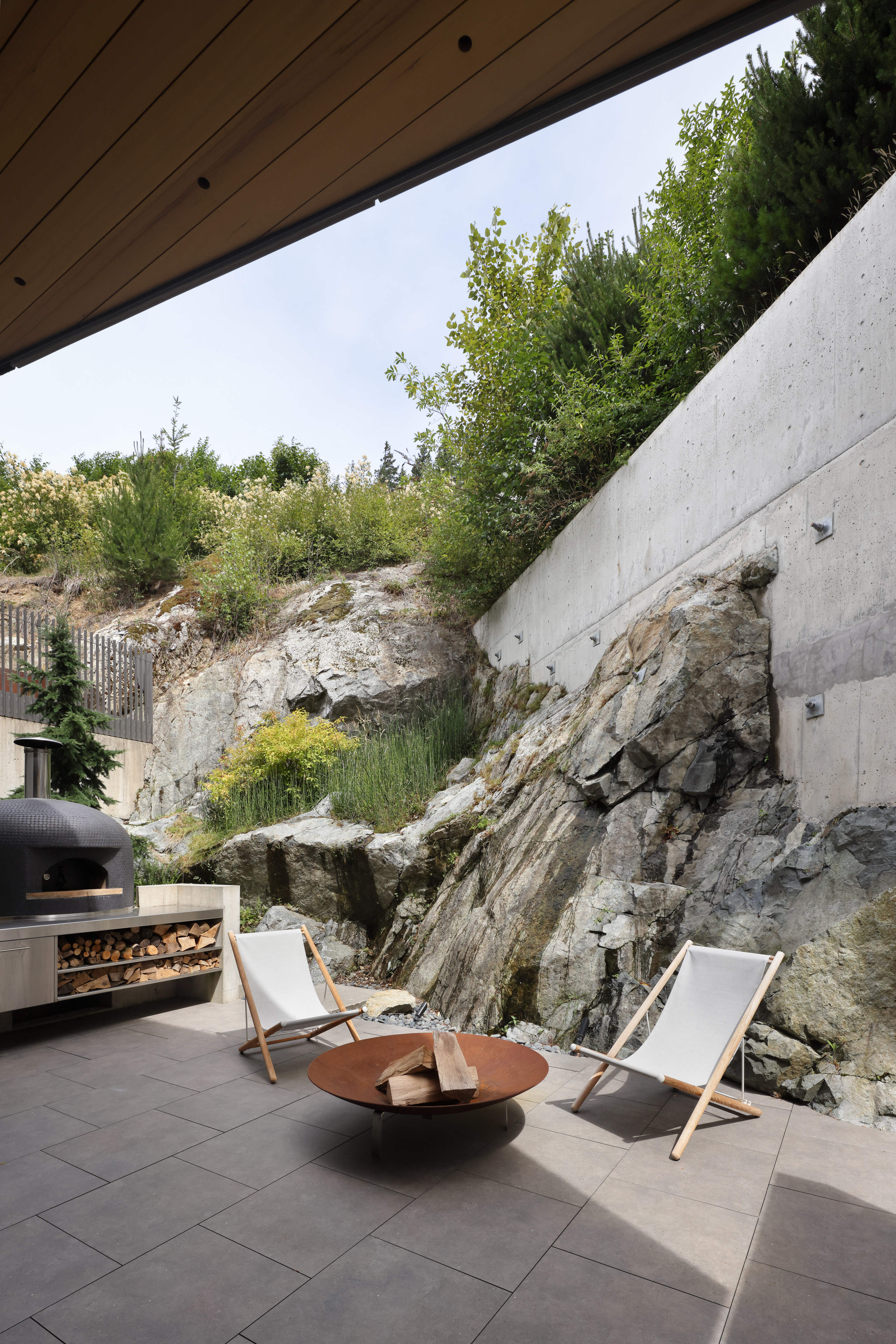 The rear terrace shows how the house is anchored into the rock