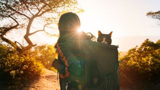 Woman hiking with cat