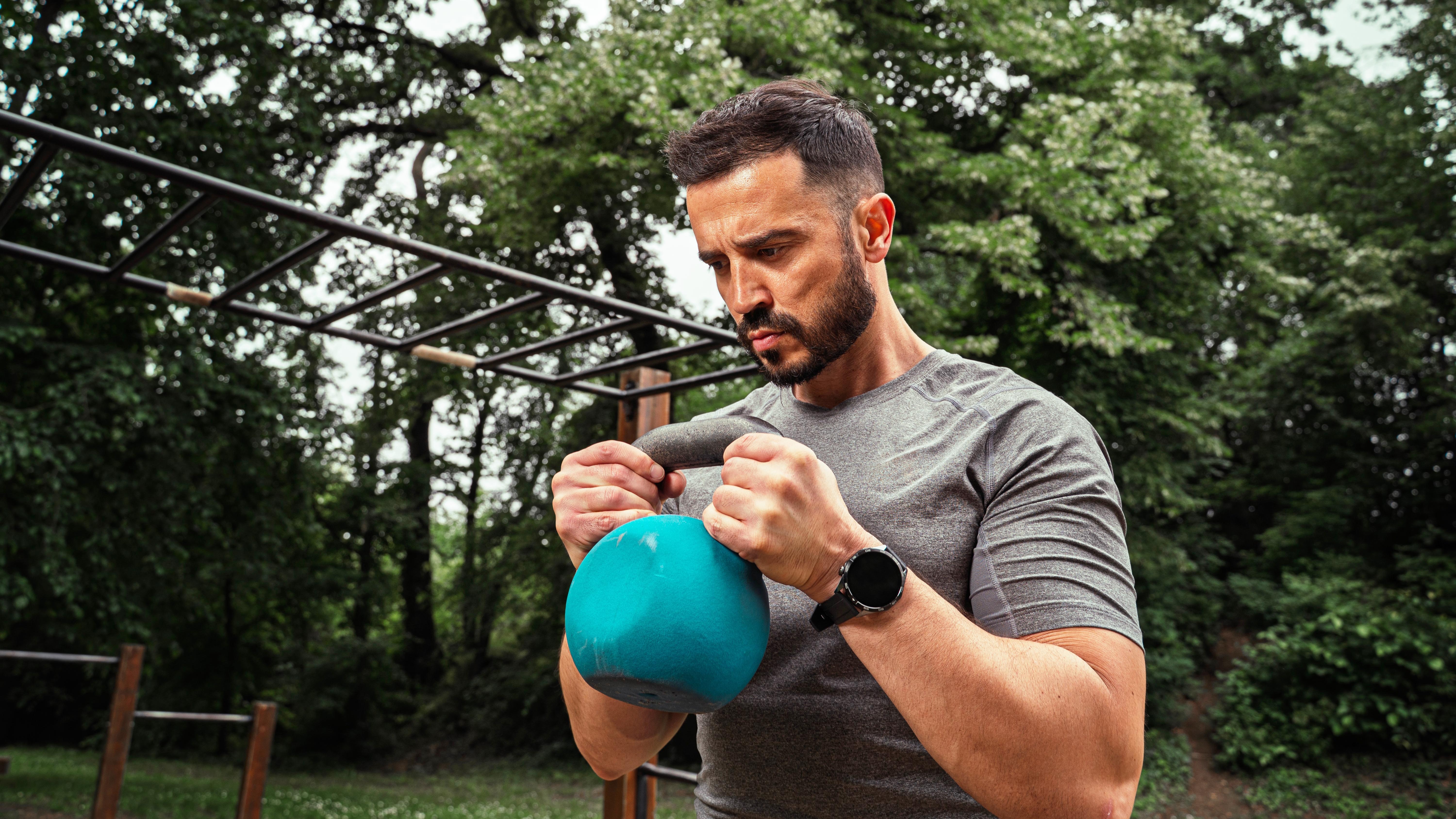 a man holding a kettlebell