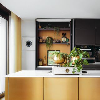 Open kitchen shelving display in gold and grey toned kitchen