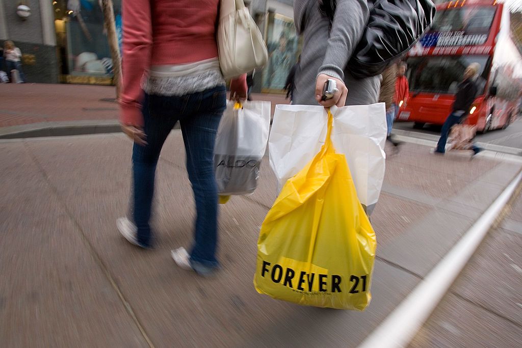 A person carries a Forever 21 shopping bag.