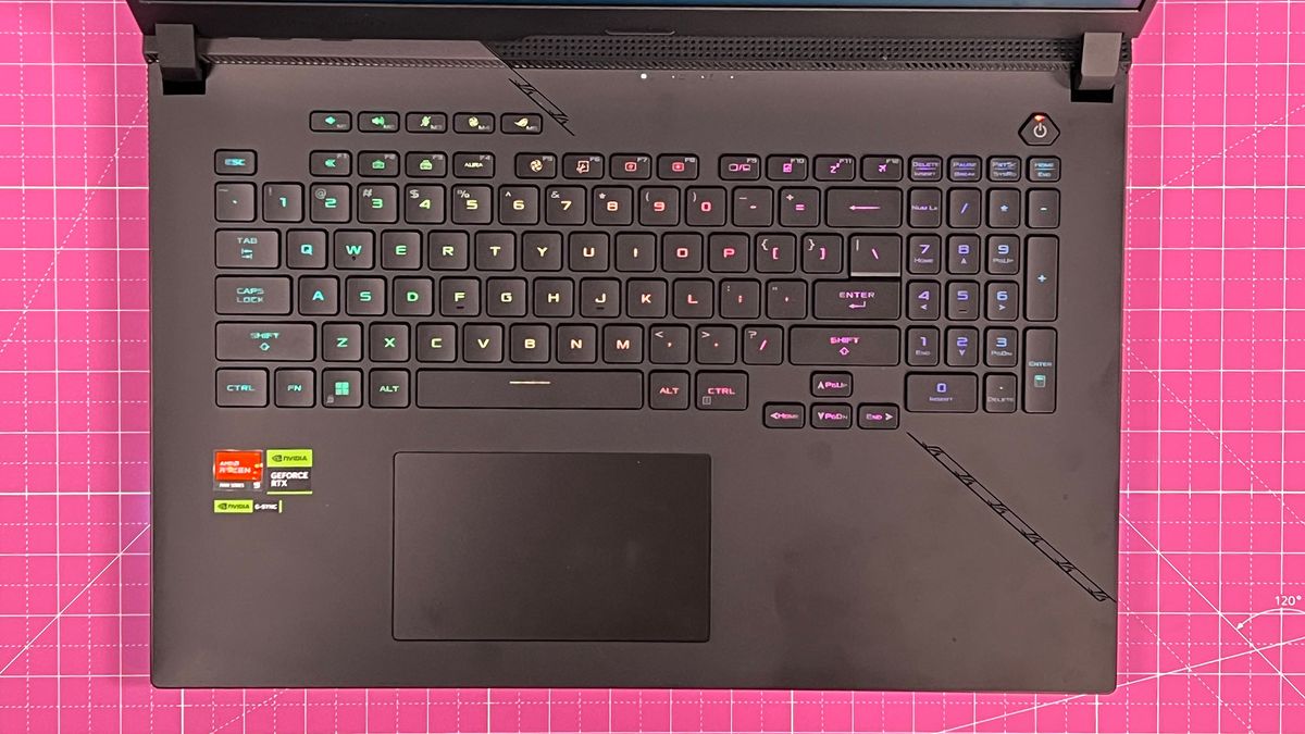 An Asus ROG Strix Scar 17 (2023) on a desk with a pink desk mat