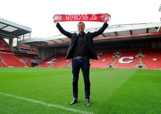 Jurgen Klopp holds a Liverpool scarf at Anfield on his unveiling as Reds manager in October 2015.