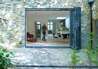 small set of bifold doors leading to brick pattern