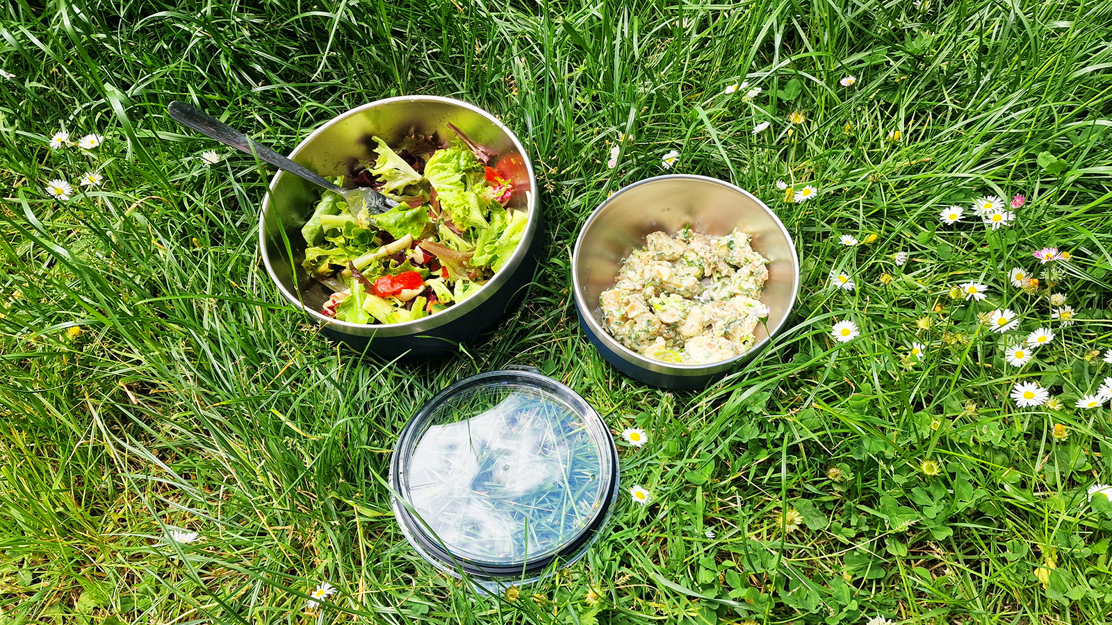 YETI Rambler with the lid off on grass in a park