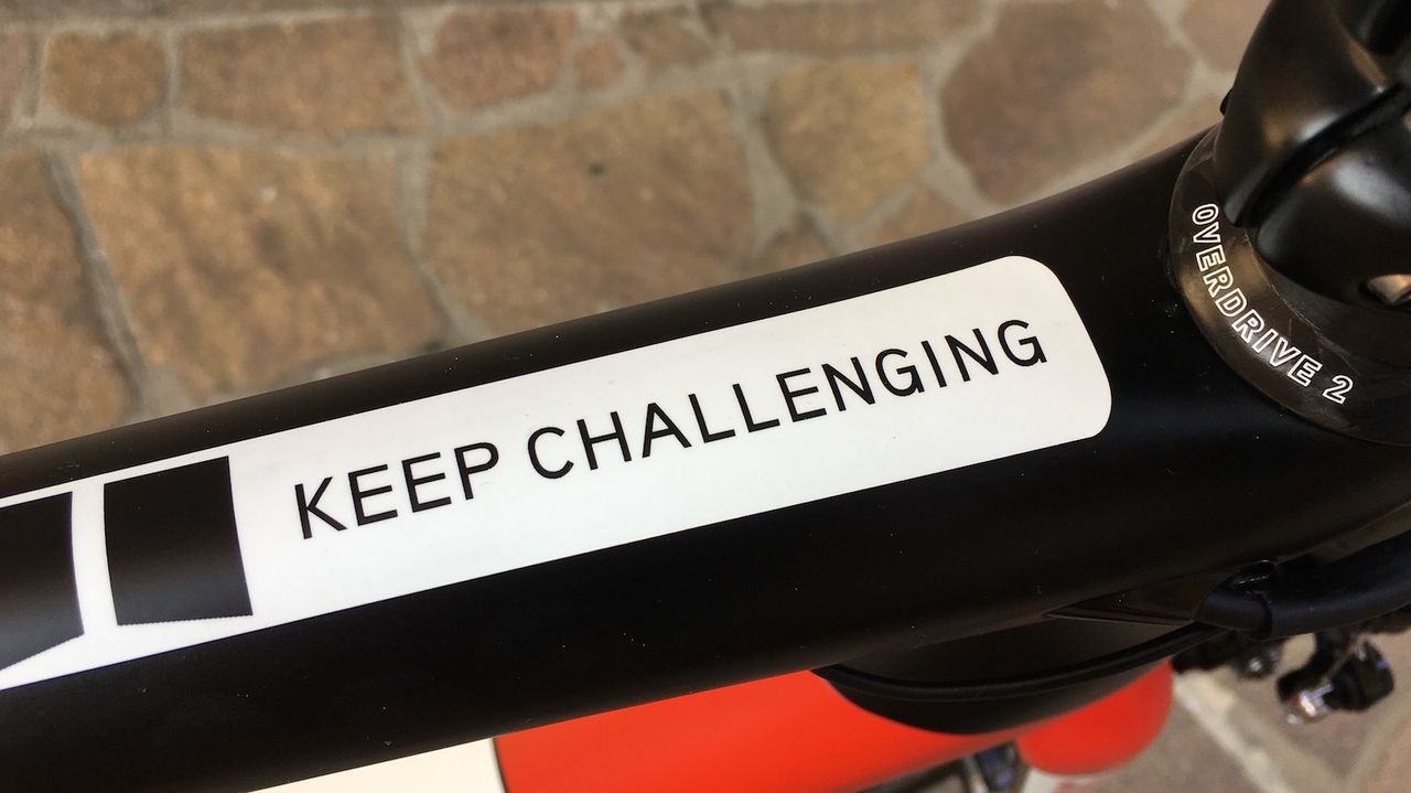 The team's motto sits on the top tube in site of Dumoulin whilst riding