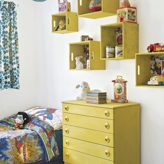 kids bedroom with yellow storage shelves