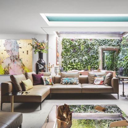 Living room in extended home, with roof windows and large opening to the garden with Mid-Century Modern furniture