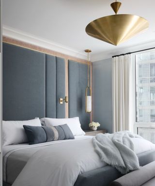 bedroom with blue-gray walls and white bedding