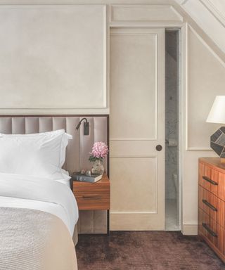 Neutral paletted bedroom with bathroom concealed behind sliding door